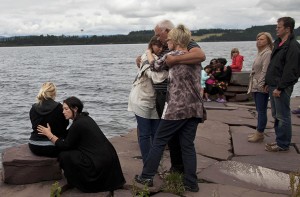 Relatives and wellwishers gather to observe a minute's silence (The Guardian)